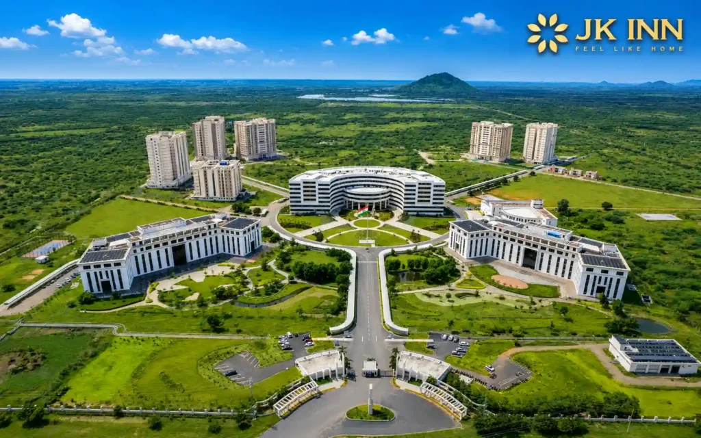 Aerial view of VIT Vellore (Vellore Institute of Technology) campus with JK Inn Vellore logo in the top-right corner, showcasing the modern university infrastructure and greenery near hotels close to VIT Vellore.