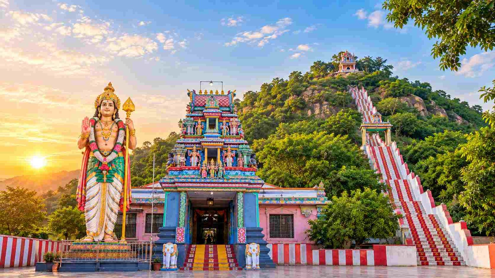 Theerthagiri Murugan Temple Vellore entrance with Murugan statue and hillside steps at sunrise